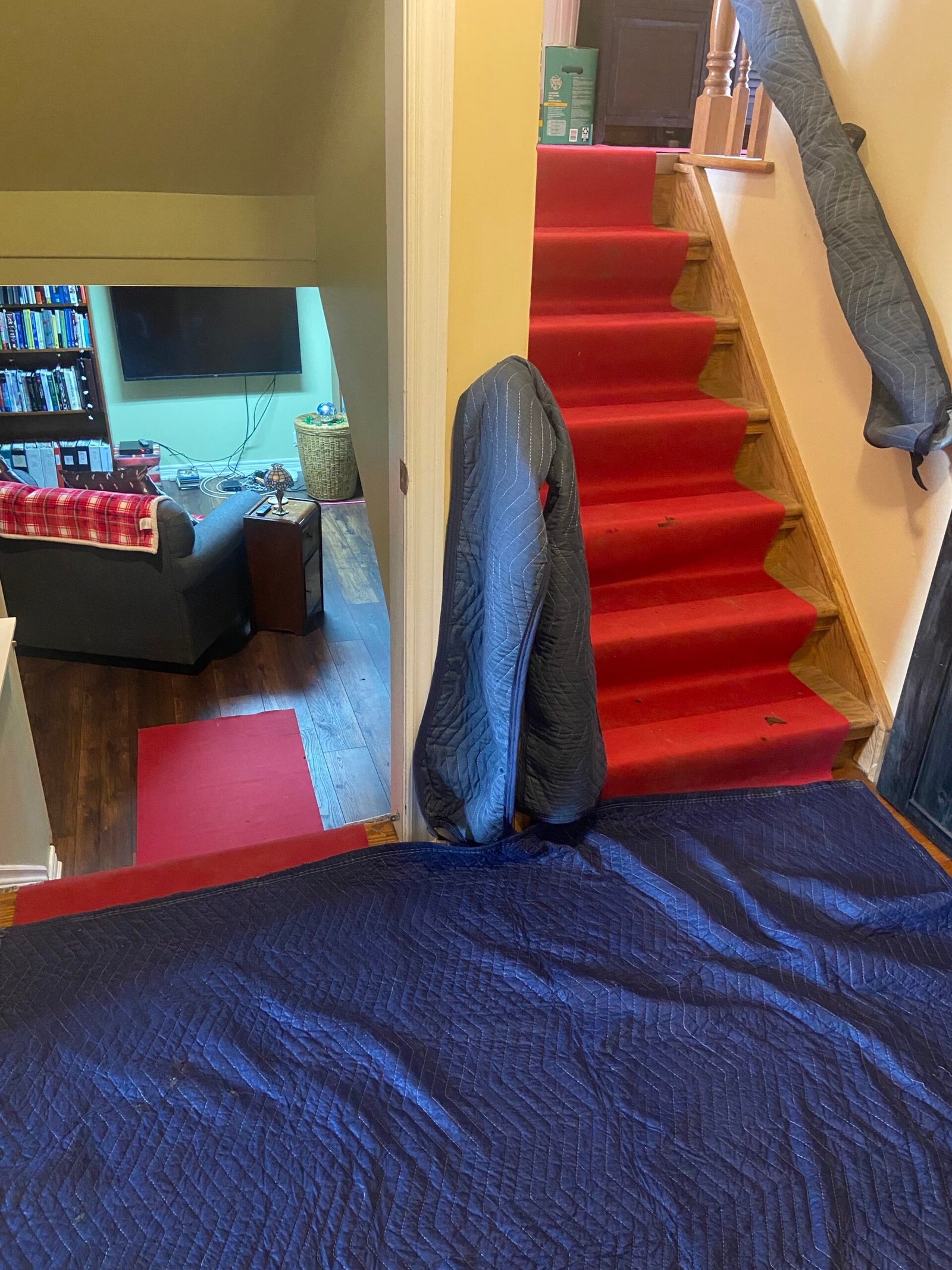 Blankets on railings and the floor, ready for the piano to be moved