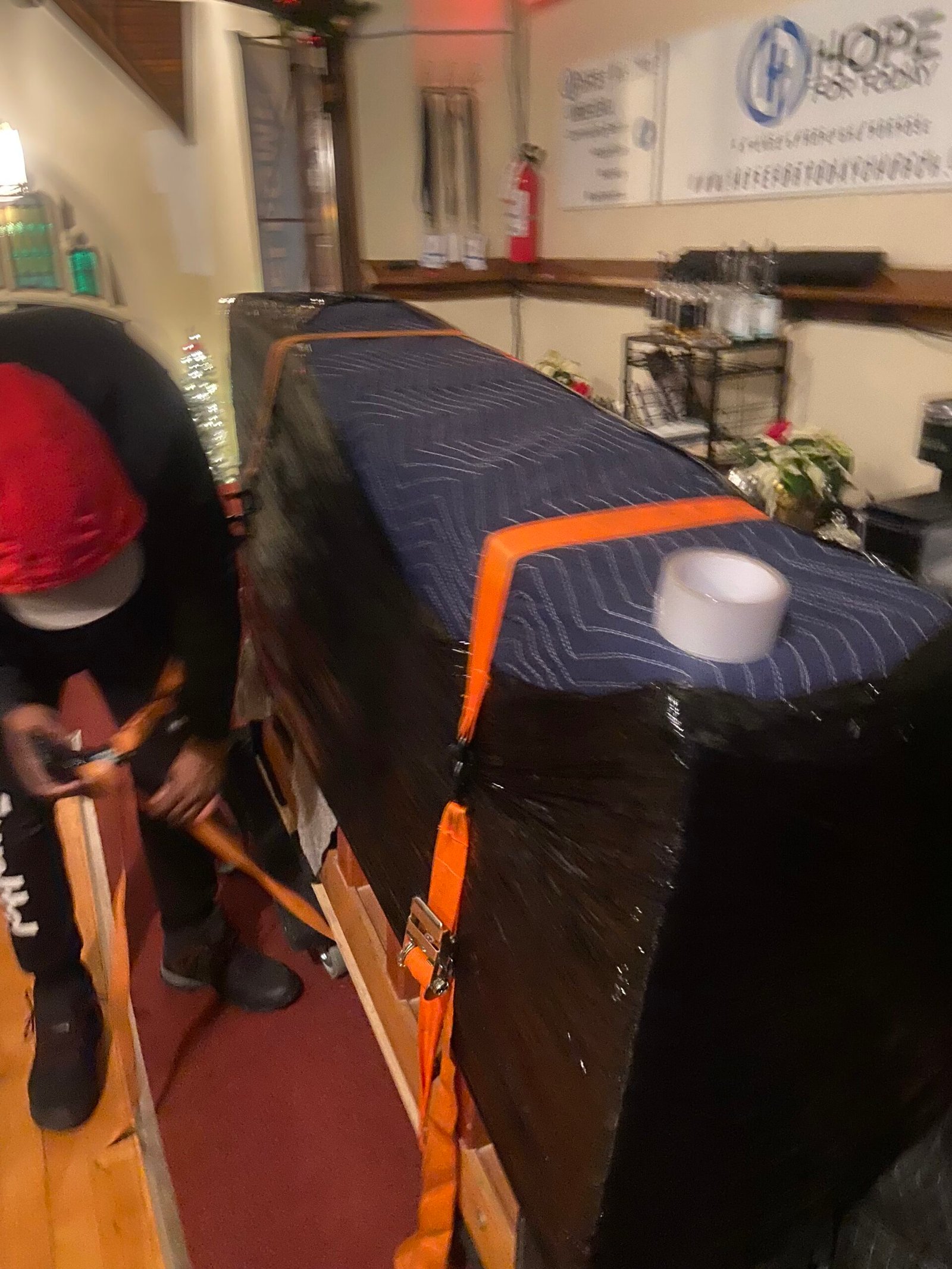 Upright piano being moved by Two Dudes, One Couch in Norfolk County